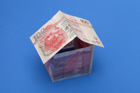 100 dollars hongkong house on blue background 
