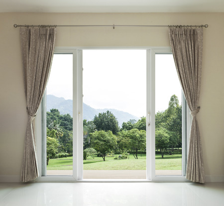 Opened door,  green garden viewの写真素材