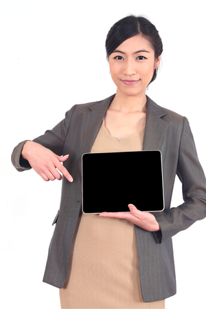 smiling young beautiful business woman holding a tablet.の写真素材