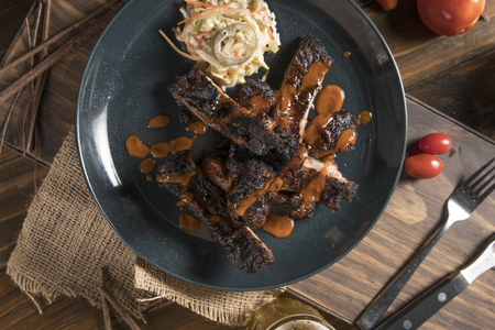 top view of barbecue ribs on a old wooden table, vintage styleの写真素材