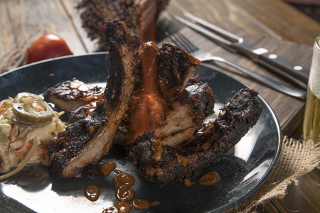 barbecue ribs on a old wooden table, vintage styleの写真素材