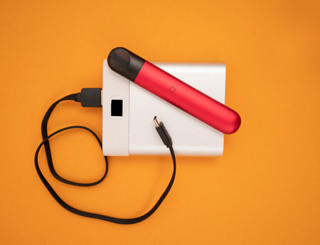 Power bank and electronic cigarette on yellow backgroungの写真素材