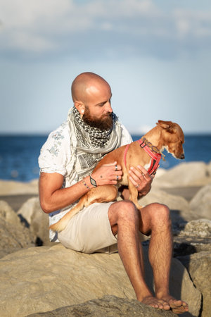 Man sitting with his dogの写真素材