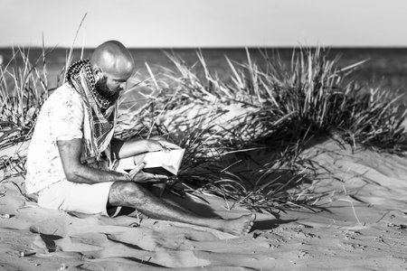Man reading on a beachの写真素材