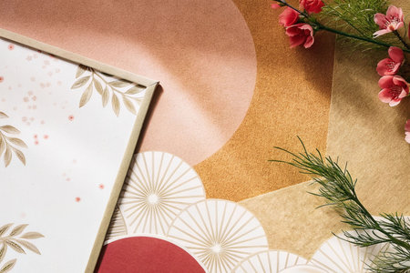 Flatlay image of flowers, frame, and patterned paper.の素材