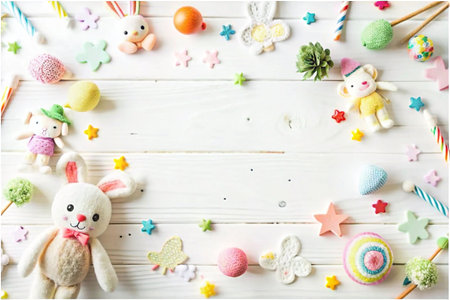 Colorful toys and decorations frame on white woodの素材