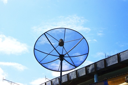 Satellite dish in blue skyの写真素材