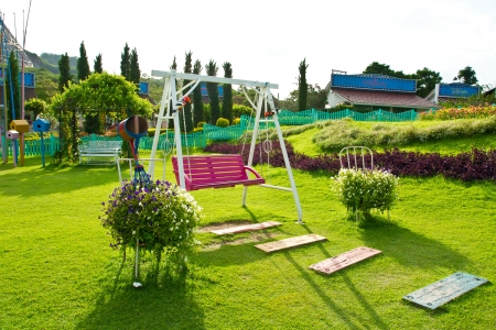 wood swing chair in the garden greenのeditorial素材