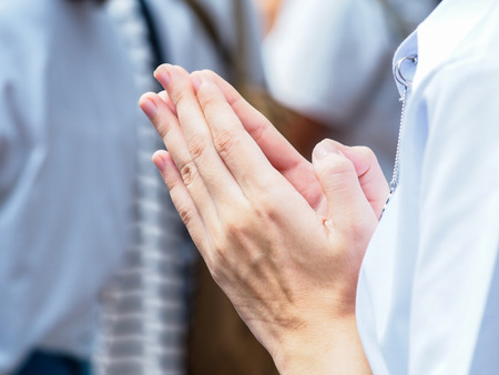 Woman put the palms of the hands together in salute.の写真素材