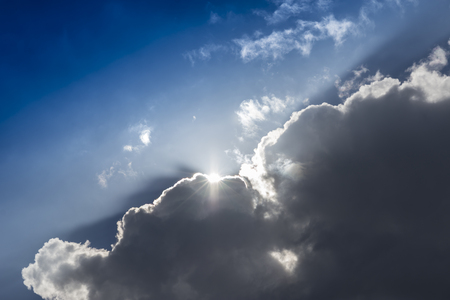 Dramatic sky  with sunbeam through the cloudの写真素材