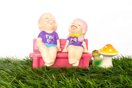 Boy and girl laugh on benchの写真素材