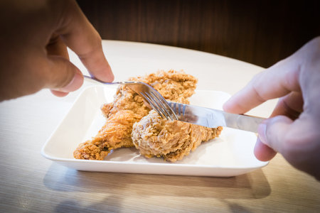 Cutting deep fried chickenの写真素材