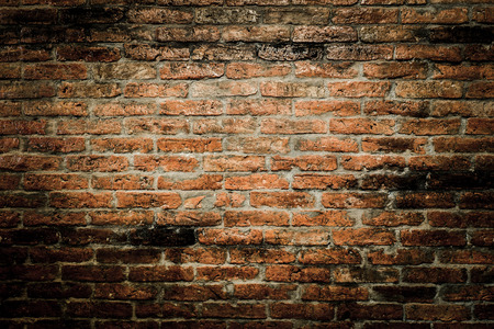 red brick wall texture grunge background with vignetted cornersの写真素材