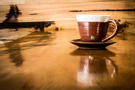 A cup of coffee on wooden backgroundの写真素材