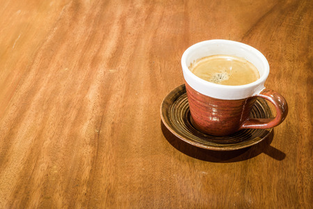 A cup of coffee on wooden backgroundの写真素材