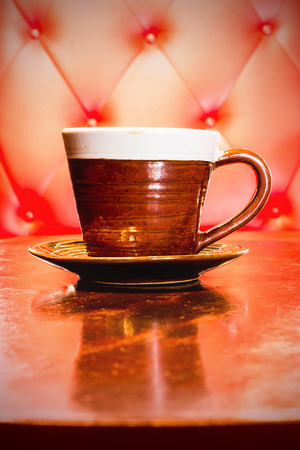 A cup of coffee on  pink genuine leather backgroundの写真素材