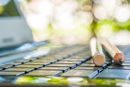 Close up of pencils on laptop keyboardの写真素材