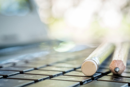Close up of pencils on laptop keyboardの写真素材