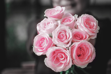 close up of roses bouquet in girl hands, shallow deep of field on rosesの写真素材