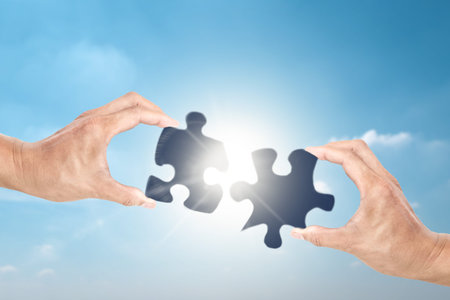 Cooperate for successful work with businessman holding jigsaw puzzle, concept of partnership