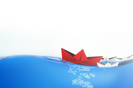 Red paper boats sailing in the sea, leadership concept.の写真素材