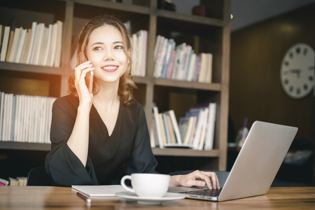 Confident happiness young woman working on laptop or notebook in her office. Beautiful Freelancer Woman working online at her home. Beauty Asian business woman concept.の写真素材