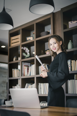 Confident happiness young woman working on laptop or notebook in her office. Beautiful Freelancer Woman working online at her home. Beauty Asian business woman concept.の写真素材
