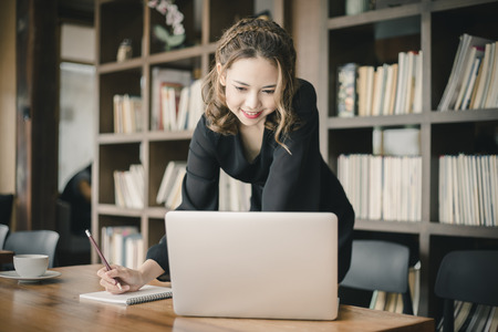 Confident happiness young woman working on laptop or notebook in her office. Beautiful Freelancer Woman working online at her home. Beauty Asian business woman concept.の写真素材
