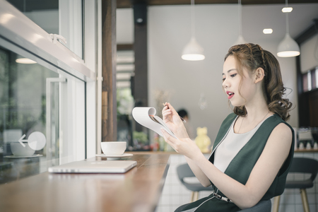 Confident happiness young woman working on laptop or notebook in her office. Beautiful Freelancer Woman working online at her home. Beauty Asian business woman concept.の写真素材