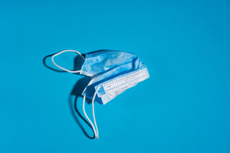 Blue face mask on blue background. Medicine and healthcare.の写真素材