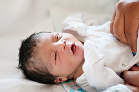 Newborn Baby Girl With Mother s Hands Getting Dressed
