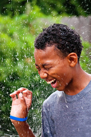 Teen boy enjoying splashing water