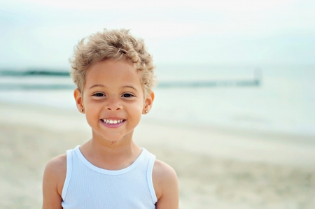 Young boy at beach smilingの写真素材