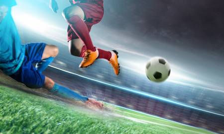 Soccer player in action kick ball at stadium.の写真素材