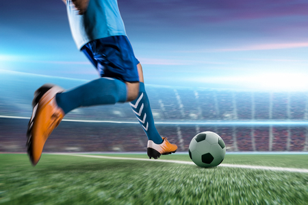 Soccer player in action kick ball at stadium.の写真素材