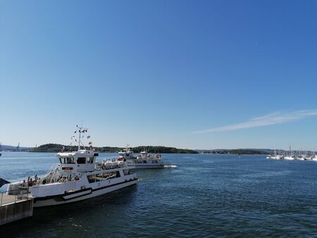 Boats leaving the dock on a clear summer dayの写真素材