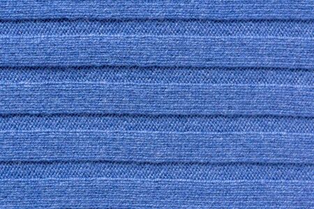 Uniform texture of expensive, exclusive knitwear made of cashmere, wool and viscose. Warm, cozy, knitted interior and costume fabric for cold weatherの写真素材