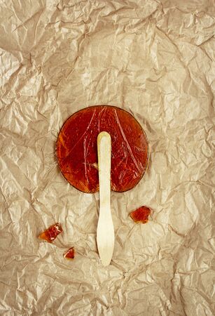 Useful sweetness. Lollipop made at home from natural ingredients on Kraft paper. Concept of environmental products. Food photo, horizontal orientation, top viewの写真素材