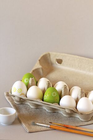 A dozen white eggs in cardboard eco-friendly packaging prepared for coloring for Easterの写真素材