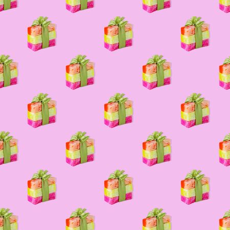 Repeating pattern of natural flower soap in a gift box on a pink backgroundの写真素材