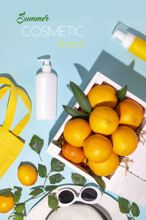 Citrus fruits in a wooden box, a summer accessories and cosmetics bottles on a blue background with easy removable sample text. Summer season cosmetics mock up. Natural, sun protection, skin careの写真素材