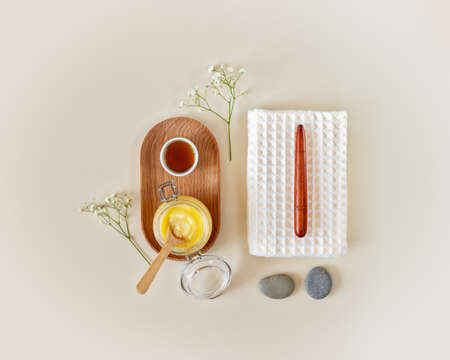 Eco friendly, wellness, spa composition with towel, citrus scrub, oil and massage stown and stick on a light background. Home skin care and spa relax treatment concept. Massage set for relax procedureの写真素材