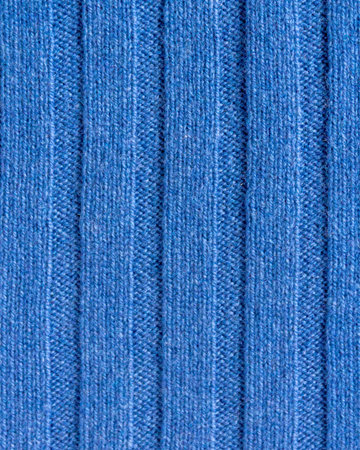 Texture of expensive natural knitted blue fabric with a striped pattern and a beautiful weave
