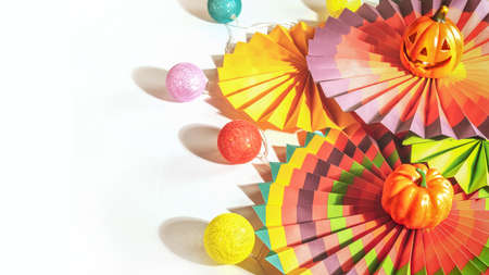 Colorful paper fans, decorative pumpkin, lightening and jack olanternの写真素材