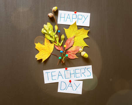 Autumn bouquet and inspiration happy teachers day on a chalkboardの写真素材