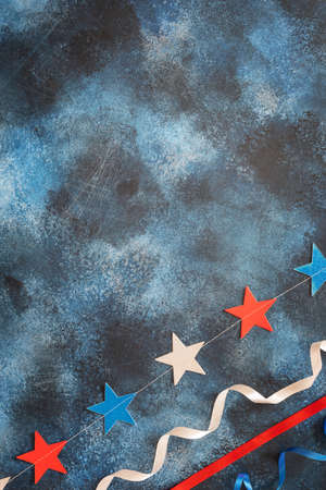 American holidays background with holiday decor on a blue texture background. holiday decor on a blue texture background. American flag colors banner with place for text suitable for national american holidaysの写真素材