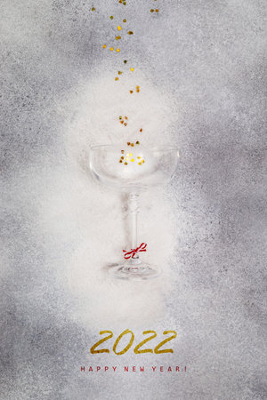 Congratulation new year banner. Holiday composition with a champagne glass and gold confetti on a...