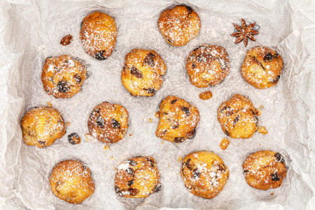Home made cookies with candied fruits and raisins on a white baking paper