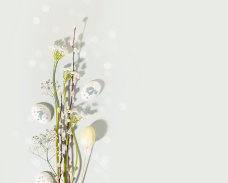 Easter bouquet with white flowers, willow twigs and decorative eggs