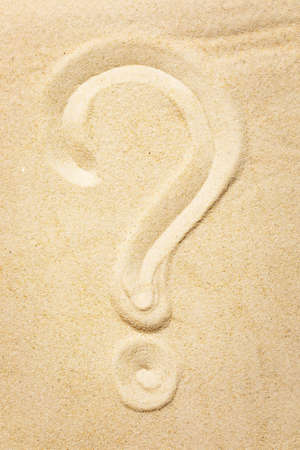 A question mark painted on the beach sand. The concept of opening a tourist business and the possibility of recreation in another country. Summer vacationの写真素材
